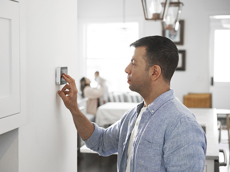 Man adjusting a thermostat